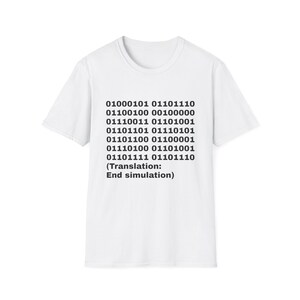 May include: A white short-sleeved t-shirt featuring black binary code printed on the front. The text reads 01000101 01101110 01100100 00100000 01110011 01101001 01101101 01110101 01101100 01100001 01110100 01101001 01101111 01101110 followed by (Translation: End simulation).