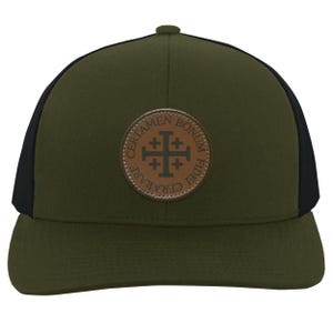 May include: Olive green trucker hat with a black mesh back. A circular brown leather patch on the front features a cross design and the words "CERTAMEN BONUM FIDEI CERARARE". The hat has a curved brim and a snapback closure.