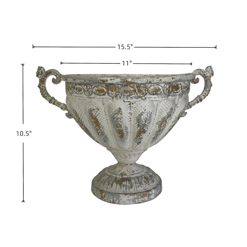 May include: A distressed white and gold-toned decorative urn, 15.5 inches wide, 11 inches in diameter, and 10.5 inches tall. The urn features ornate handles and a pedestal base, suitable for home decor or floral arrangements.