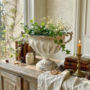 May include: A set of three ceramic mugs with a speckled, matte finish. The mugs are in shades of cream, light gray, and dark gray. Each mug has a simple, minimalist design, perfect for coffee or tea.