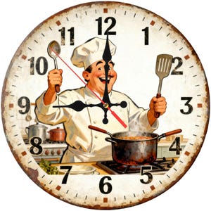 May include: Round wall clock with a vintage design featuring a smiling chef in a white uniform, holding a spoon and spatula. The clock face has black numbers and hands, with a red second hand. The clock has a distressed, rusty brown border.