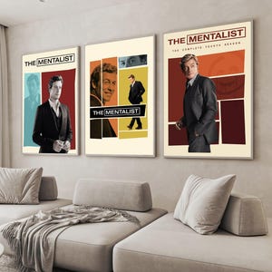 May include: Three vertical wall art prints featuring The Mentalist television series. The posters display photographic portraits of a man in a suit against geometric blocks of cream, red, blue, and yellow, with the text The Mentalist.