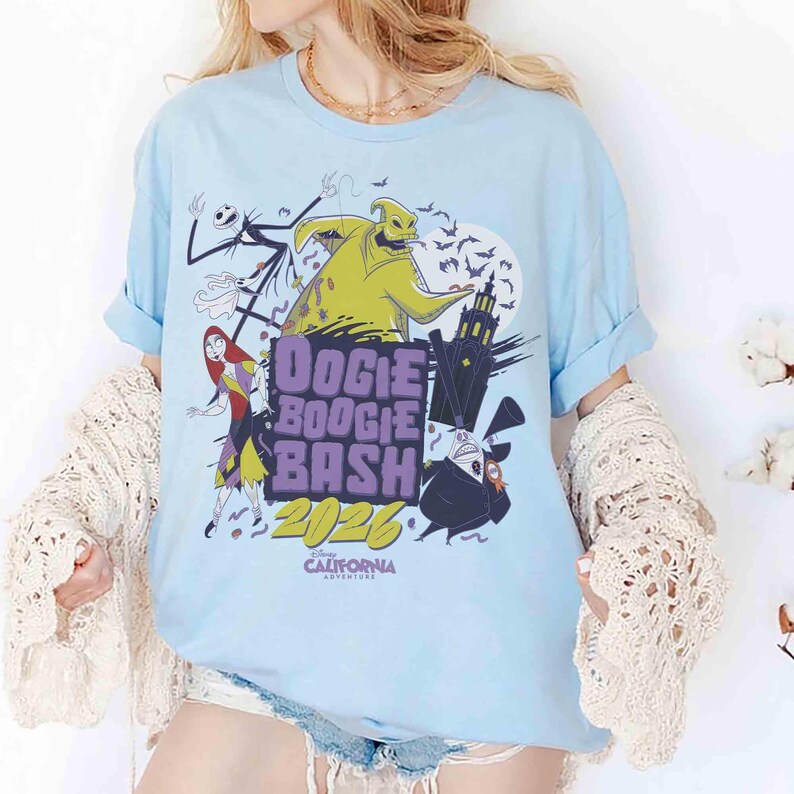 May include: Light blue t-shirt featuring characters from The Nightmare Before Christmas. The shirt has the text "Oogie Boogie Bash 2026" and "California Adventure". The design includes Jack Skellington, Sally, Oogie Boogie, and Zero.