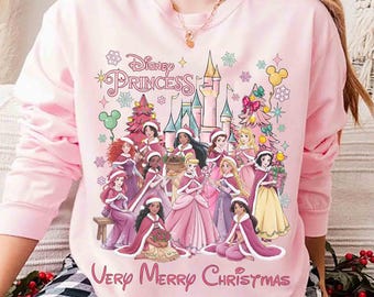 Comfort Colors® Disney Princess Very Merry Christmas Shirt, Disney Belle Ariel Tiana Elsa Rapunzel Pink Xmas Light Tee, Girly Xmas Trip Gift