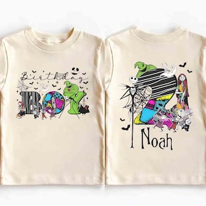 May include: Two cream-colored short-sleeve t-shirts featuring graphic prints inspired by The Nightmare Before Christmas. One shirt displays the text Birthday Boy with characters and spiderwebs. The other shows a large number 2, the name Noah, and characters.