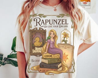 Koszulka z książką „Roszpunka i Pascal: Spełnij swoje marzenia”, koszulka z księżniczką Disneya „Zaplątani” z 2010 r., Przytulne kaczątko „Kwiat w kształcie kropli słońca”, Korona