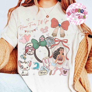 May include: Cream-colored t-shirt with a colorful graphic design featuring the text "How Far I'll Go" and various cartoon elements. The design includes a portrait of a character, bows, and other themed illustrations.