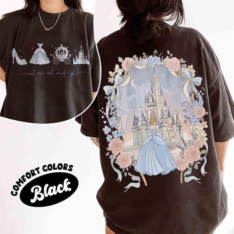May include: Black Comfort Colors t-shirt featuring a Cinderella-themed design. The front displays a shoe, dress, carriage, and castle with the text "meet me at midnight." The back showcases Cinderella in front of a castle, surrounded by flowers.