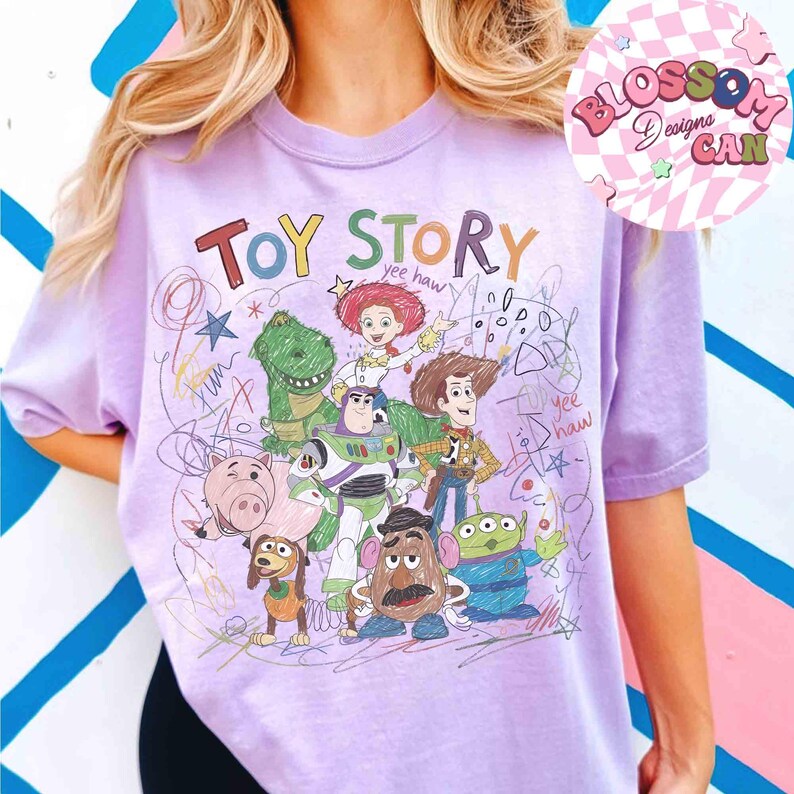 Puede incluir: Una camiseta lila claro con un gr&aacute;fico colorido de personajes de la pel&iacute;cula "Toy Story". El dise&ntilde;o incluye las palabras "Toy Story" e ilustraciones de los personajes, con la frase "yee haw" en el dise&ntilde;o.