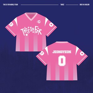May include: Pink and white graphic jersey with the text "THIS IS FOR" and "JEONGYEON 0". The jersey has a V-neck and vertical stripes. The text "TWICE" and "ONE IN A MILION" are also visible.