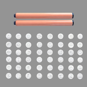 May include: A selection of white, circular embossing stamps featuring diverse designs such as flowers, hearts, and butterflies. Two orange and blue handled tools are positioned above the stamps. The stamps are arranged on a grey background.