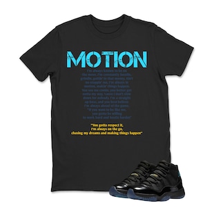 May include: Black t-shirt with the word "MOTION" in blue, along with a poem. The shirt is paired with black and blue sneakers. The text on the shirt includes phrases like "chasing my dreams" and "making things happen."