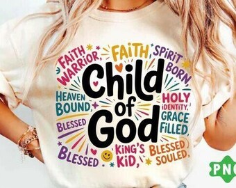 May include: A cream-coloured t-shirt with a vibrant graphic. The design prominently displays "Child of God" in black, encircled by words such as "Faith Warrior" and "Blessed." The t-shirt has short sleeves and a round neckline.