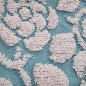 Lovely white tufted rose floral on aqua. This Vintage Chenille Fabric measures 24x18”. So pretty for your next project
