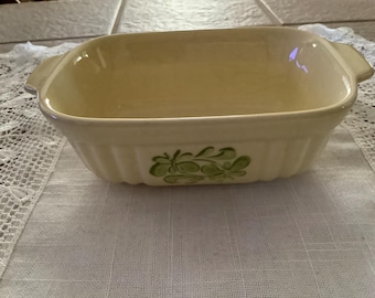 Vintage 1983 F.T.D.A. Yellow Stoneware Baking Dish. 7 1/4” from handle to handle,4 3/4” wide,2 1/2” high. There is grazing.