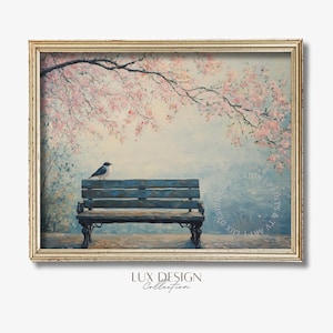Puede incluir: Impresión enmarcada de una escena de parque con un banco azul y un pequeño pájaro. Flores rosas cuelgan de un árbol arriba. La obra de arte tiene una estética vintage, con el texto "LUX DESIGN Collection" en la esquina inferior izquierda.
