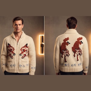 May include: Cream-coloured zip-up cardigan sweater with a shawl collar. The front features two fox designs in red, black, and white. The back of the sweater has two additional fox designs. Blue and white snowflake patterns are at the bottom.