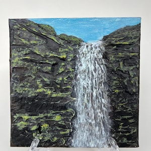 May include: Square textured painting of a waterfall cascading down dark, rocky cliffs. The water is white, contrasting with the black and green rocks. A blue sky is visible at the top, creating a serene landscape.