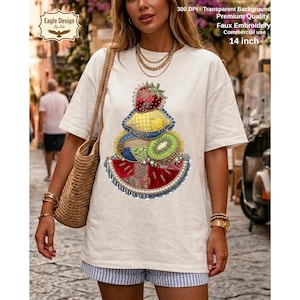 May include: Cream-colored t-shirt featuring a colorful fruit design with strawberry, kiwi, and watermelon elements. The design is faux embroidery. The text on the shirt reads "300 DPI - Transparent Background Premium Quality Faux Embroidery Commercial use 14 inch".