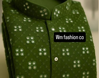 May include: Olive green embroidered shirt with a mandarin collar and button-down front. The shirt features a repeating floral pattern with small white accents. The text "Wm fashion co" is visible on the front.