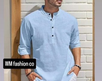 May include: A light blue Henley shirt with black buttons and rolled-up sleeves. The shirt is paired with white shorts. The text "WM fashion co" is displayed on a black rectangle.