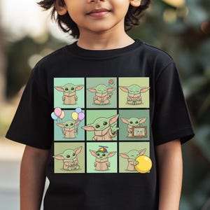 May include: Black t-shirt with a grid of nine cartoon images of a green alien character. Each image shows the character in different poses, some holding balloons, a cookie, or a yellow ball. The character wears a tan robe.