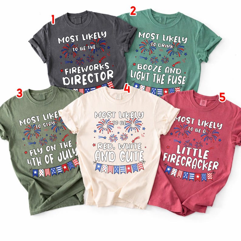May include: Five t-shirts in various colors, each with a unique patriotic-themed graphic. The shirts feature phrases like "Most Likely to be the Fireworks Director" and "Red, White, and Cute," with firework and flag illustrations.