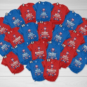 May include: A collection of red and blue t-shirts with various phrases and graphics related to fireworks. Each shirt features the text "The Firecracker" along with adjectives like "Sassy," "Loud," and "Naughty."