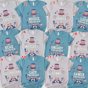 May include: A collection of twelve short-sleeved t-shirts with various phrases related to fireworks. Each shirt features a patriotic Uncle Sam hat, fireworks, and the American flag. The phrases include "Sassy," "Bougie," and "Gamer."