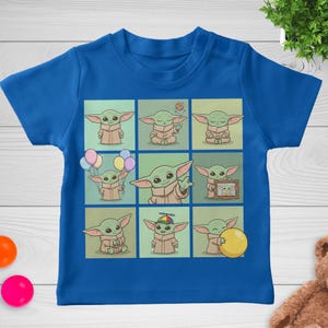 May include: A blue t-shirt with a grid of nine illustrations of a green alien character. Each illustration shows the character in different poses, some holding balloons, a cookie, or a yellow ball. The shirt is made of a soft material.