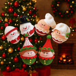 May include: A collection of handmade Christmas ornaments, including snowmen, Santa Claus, and elves. The ornaments are crocheted with red, white, green, and black yarn. Each ornament has a smiling face and festive details, perfect for holiday decorating.