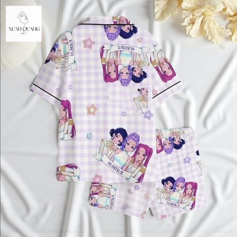 a pair of pajama bottoms with a cartoon-style print of a group of girls, along with a floral pattern.