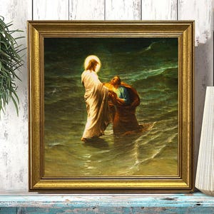 May include: A framed print of a religious scene showing a figure in white robes in water, reaching out to another figure. The artwork is in a gold frame, set against a weathered, blue-painted surface.