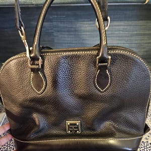 Large Dooney and Bourke black pebbled leather bag clean inside and out! Double strap! 13*9. Free Shipping in US!