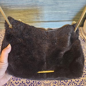 Steve Madden black faux crossbody with a gold strap fur purse in very good condition!