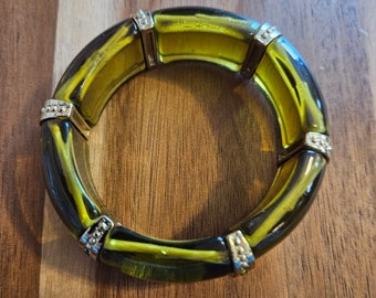 Vintage olive green stretch bracelet with crystals in the center of the spacer beads. Beautiful and elegant.