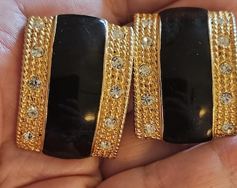 Vintage statement goldtone clip on earrings with a center black stripe and crystals. Close to 1.5 inches in length