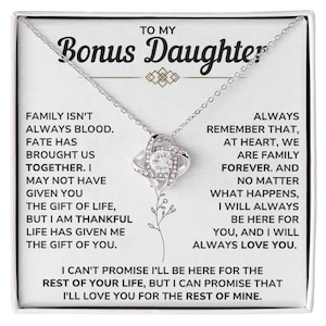 May include: A silver-toned necklace with a pendant featuring a central clear stone surrounded by smaller stones. The necklace is presented on a white card with text that reads "TO MY Bonus Daughter" and a heartfelt message.