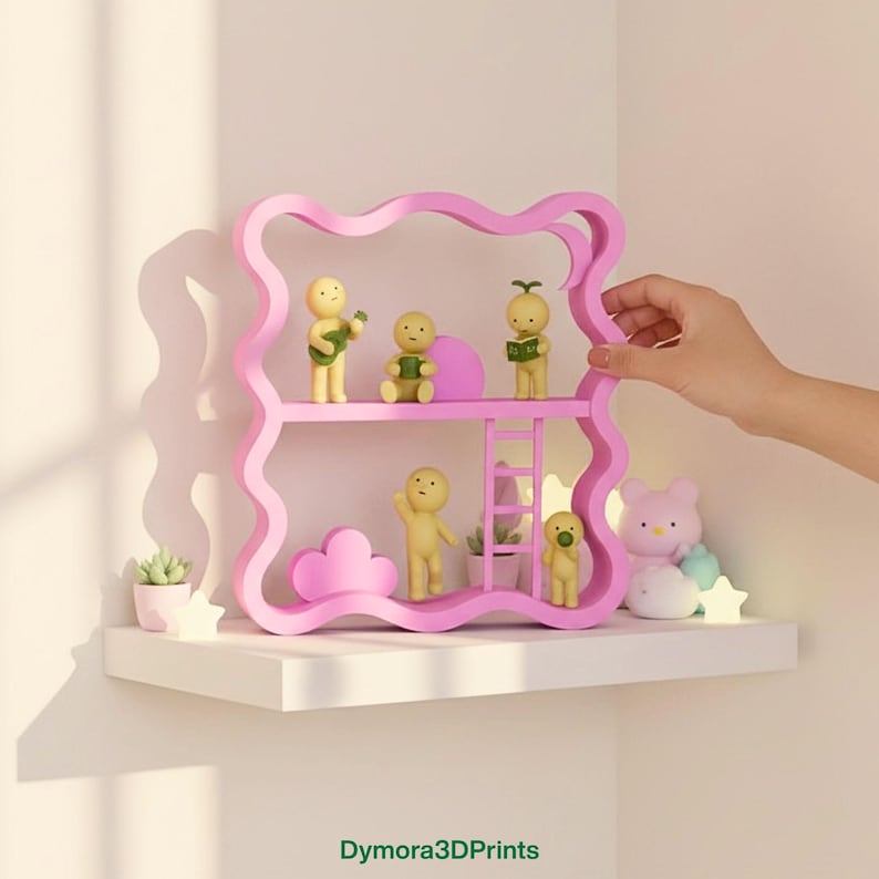 May include: A pink, wavy-edged shelf unit with two levels, holding small figurines and decorative items. The figurines are yellow and the shelf has a ladder. A hand is touching the shelf. The text "Dymora3DPrints" is at the bottom.