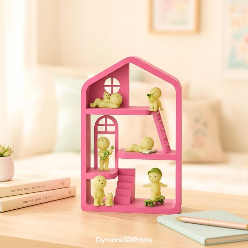 May include: A bright pink, house-shaped shelf unit with several small, yellow figurines in different poses. One figurine is on a skateboard, another is playing a guitar, and others are relaxing. The shelf has a window and a ladder. The text "Dymora3DPrints" is at the bottom.