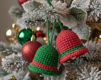 May include: Close-up of a Christmas tree adorned with red and green crochet bell ornaments. The bells have green and red stripes. Other ornaments include red and green baubles and gold spheres.