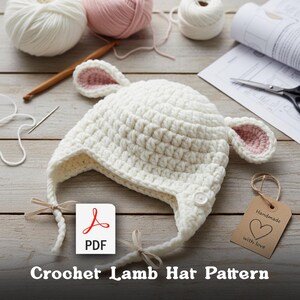May include: A white crochet lamb hat with pink inner ears, tied with strings. The hat is on a wooden surface with yarn, a crochet hook, and a PDF pattern. The text "Crochet Lamb Hat Pattern" is at the bottom.