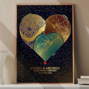 May include: A framed print featuring a heart-shaped design composed of gold-toned map sections. The maps represent the United States, London, and Italy. The print includes the names "STUART & MELISSA" and the text "ADVENTURING TOGETHER 10TH MARCH 2025".