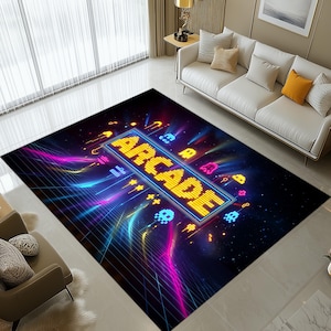 May include: A rectangular rug with a retro arcade game design. The rug displays the word "ARCADE" in yellow pixelated letters, surrounded by colourful neon graphics and retro game characters on a dark background.
