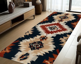 May include: A rectangular area rug with a geometric pattern in shades of navy blue, cream, red, and orange. The rug features a central diamond shape with smaller geometric designs and a zig-zag border.