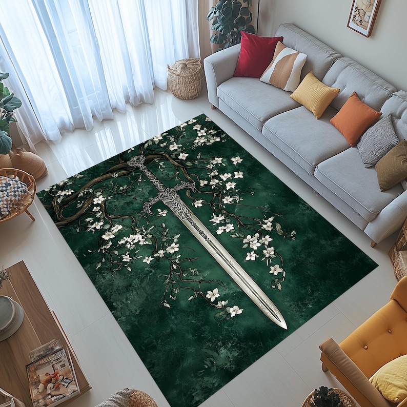 May include: A rectangular area rug with a dark green background featuring a detailed illustration of a silver sword, tree branches, and white flowers. The rug is designed to be placed on a floor.