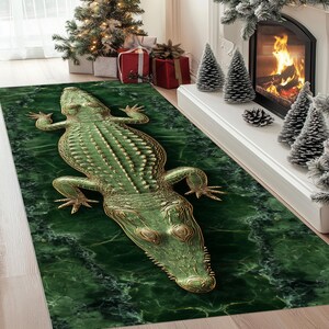 May include: A green and gold alligator-shaped rug with a marble-like background. The rug features detailed scales and claws. The rug is placed in front of a fireplace and Christmas tree.