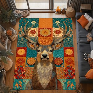 May include: A decorative area rug featuring a detailed deer head design with large antlers. The rug has a patchwork pattern with floral and geometric elements in teal, orange, and brown tones. The rug is rectangular.