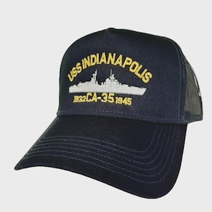 May include: Navy blue trucker hat with the text "USS INDIANAPOLIS" embroidered in gold above a white ship illustration. The hat also features the text "1932 CA-35 1945". The hat has a mesh back and a curved brim.