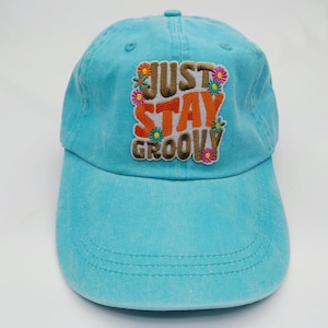 May include: A white ceramic mug with a black handle and the text "But First, Coffee" in a handwritten style. The mug is on a white surface. The mug is approximately 4 inches tall.